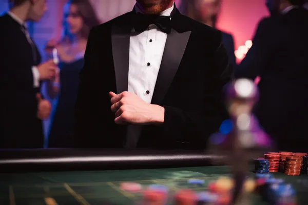 A young woman relaxing with her phone while dynamic casino elements float around her, illustrating the smooth mobile experience offered by the SAGISAGPH app.