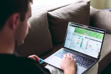 A cheerful woman in traditional clothing using her smartphone during a festive moment, showing how easily the SAGISAGPH app fits into everyday life.