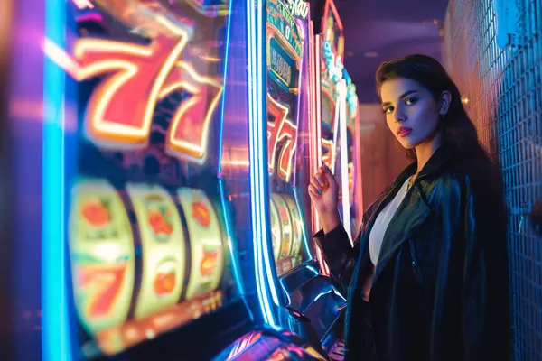 A glamorous woman holding casino chips in a neon-lit environment, representing the premium online casino atmosphere of SAGISAGPH.