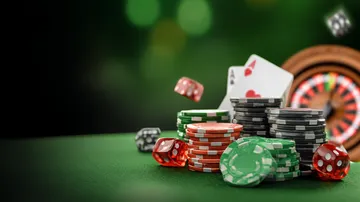 A close-up shot of golden coins falling around a spinning roulette wheel, representing immersive casino action at SAGISAGPH.